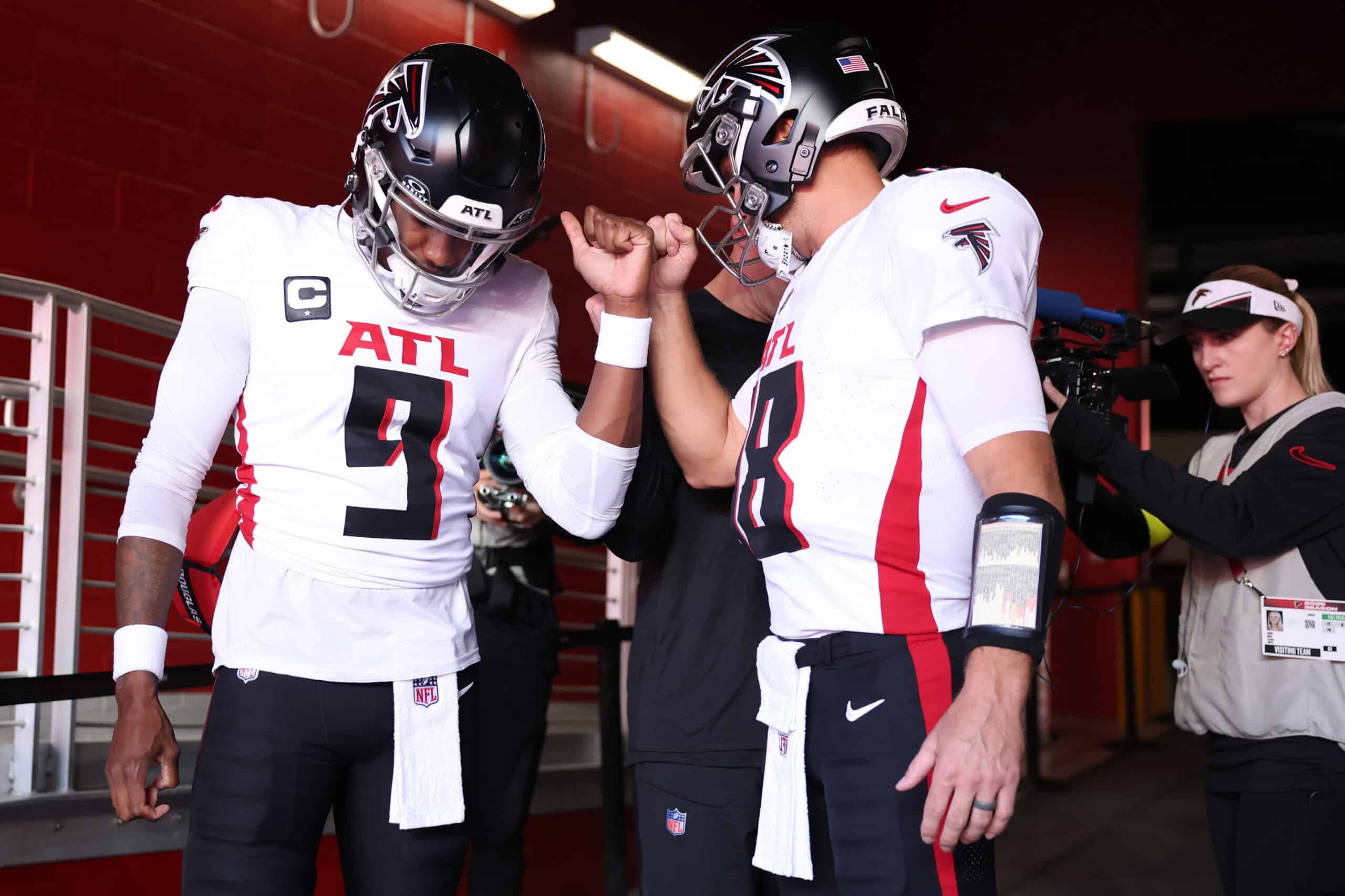 SANTA CLARA, CALIFORNIA - OCTOBER 19: Michael Penix Jr. #9 and Kirk Cousins #18 of the Atlanta Falcons huddle in the tunnel ahead of the game against the San Francisco 49ers at Levi's Stadium on October 19, 2025 in Santa Clara, California.