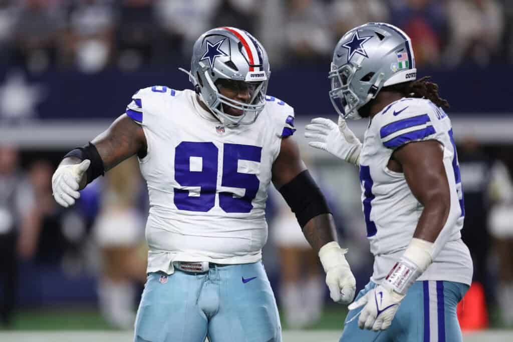 ARLINGTON, TEXAS - NOVEMBER 03: Kenny Clark #95 of the Dallas Cowboys and Osa Odighizuwa #97 after a sack during the fourth quarter in the game at AT&T Stadium on November 03, 2025 in Arlington, Texas.